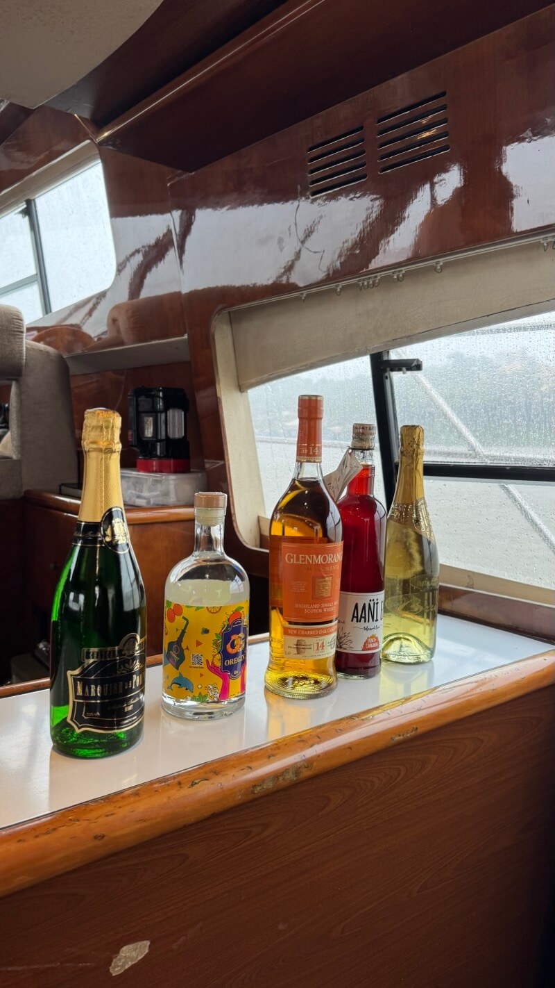 Champagne, gin, single malt and wine lined up on the bar counter aboard the Ambassador yacht in Goa