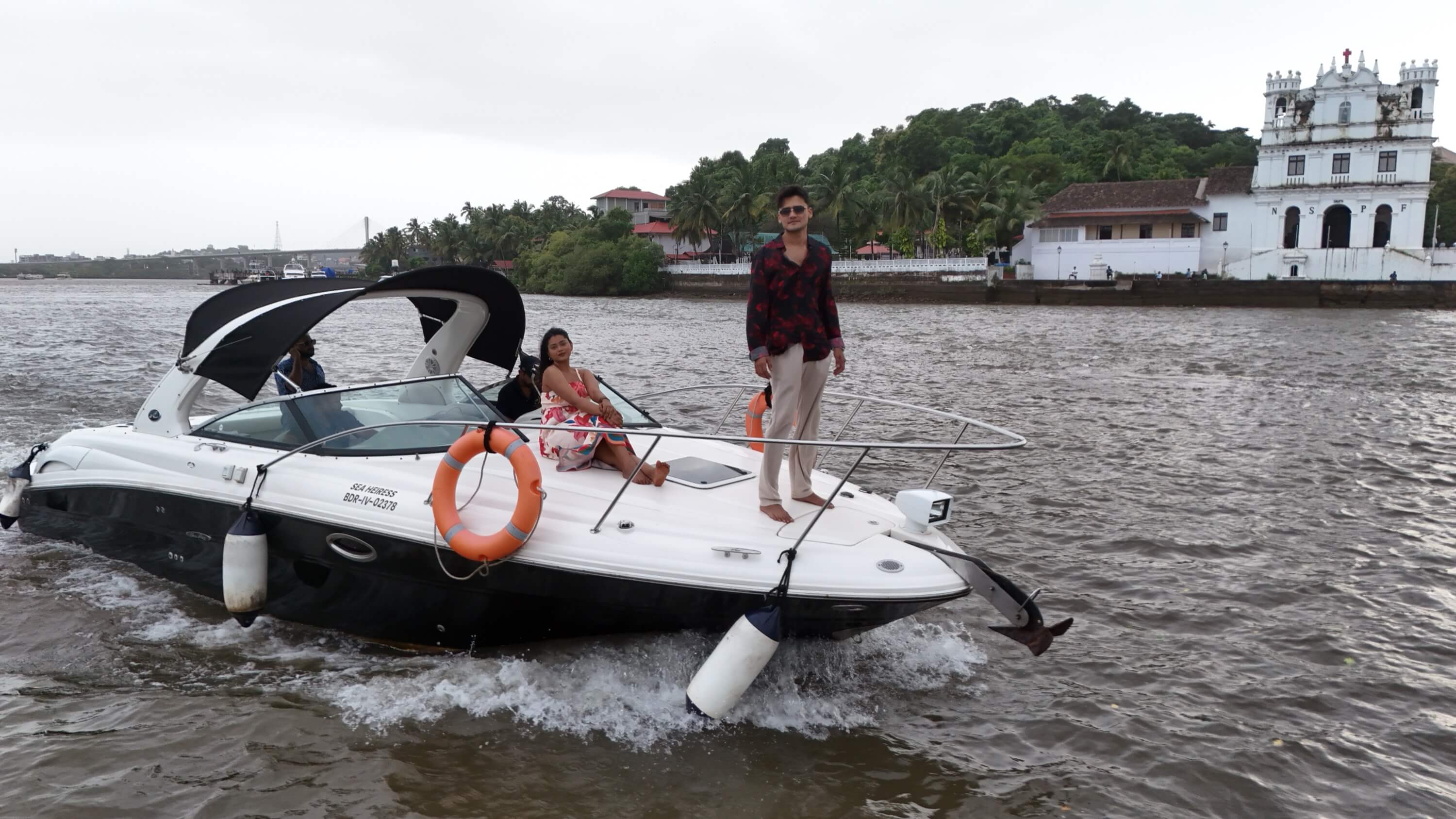 Solstice yacht planing across open water in Goa with guests on the bow